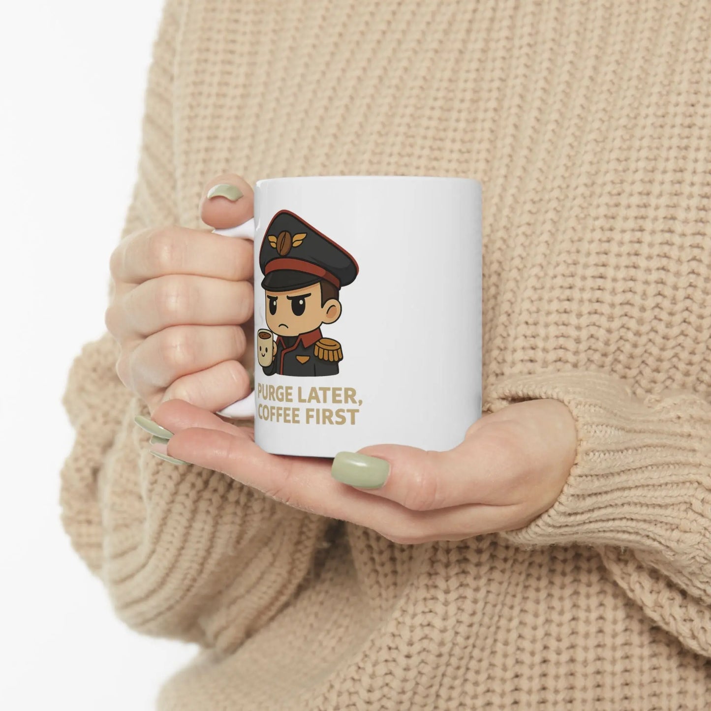 Person holding a mug with a character design and text 'Purge Later, Coffee First' against a beige background.