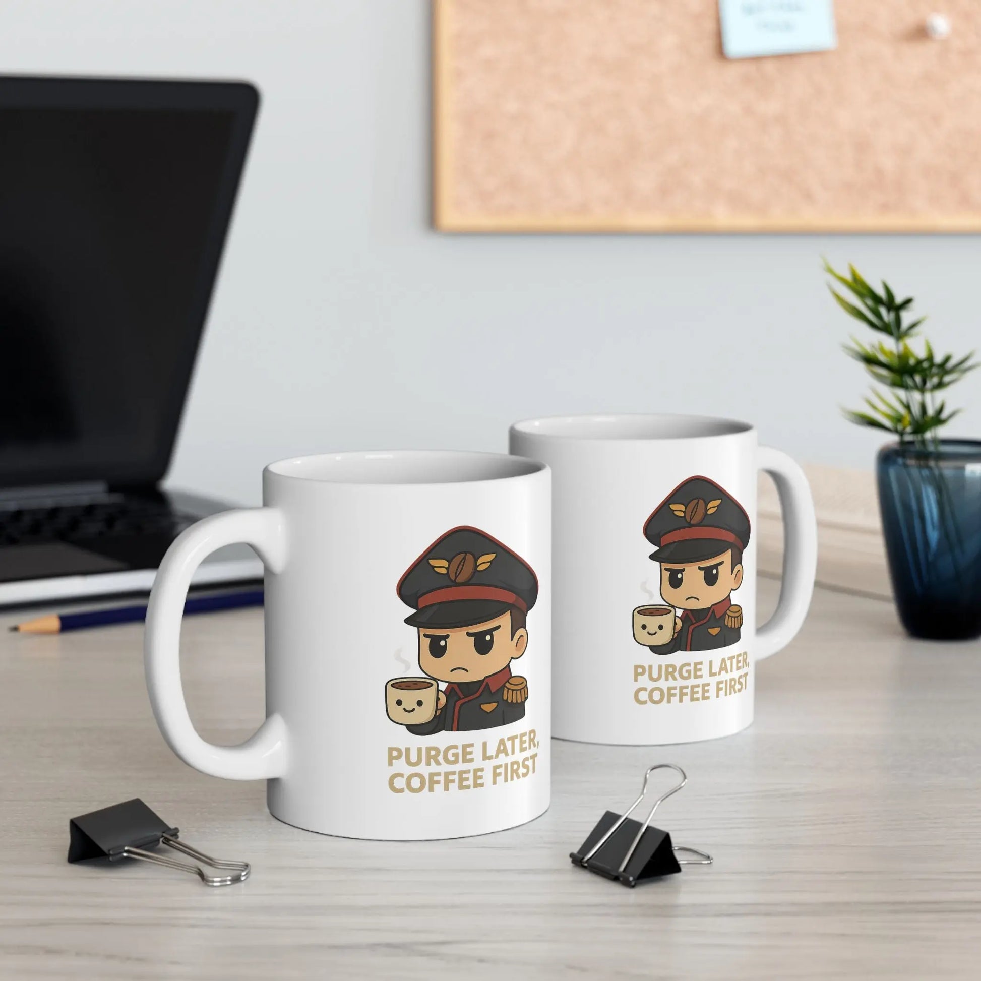 Two mugs with cartoon character design and text on a desk with office items.